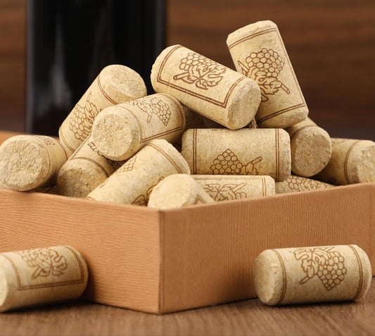 Wooden box filled with soft wood cork stoppers on a wooden surface.