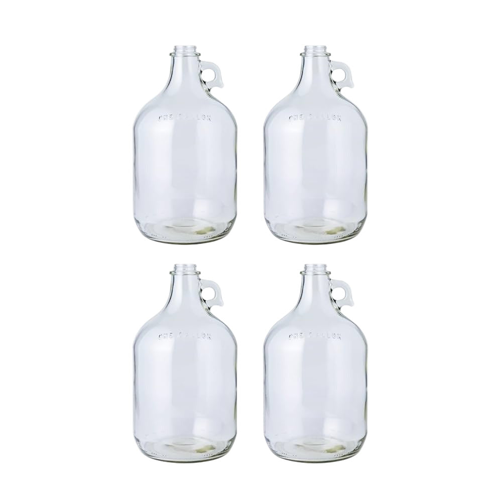 Four clear 1 gallon glass jugs on a white background